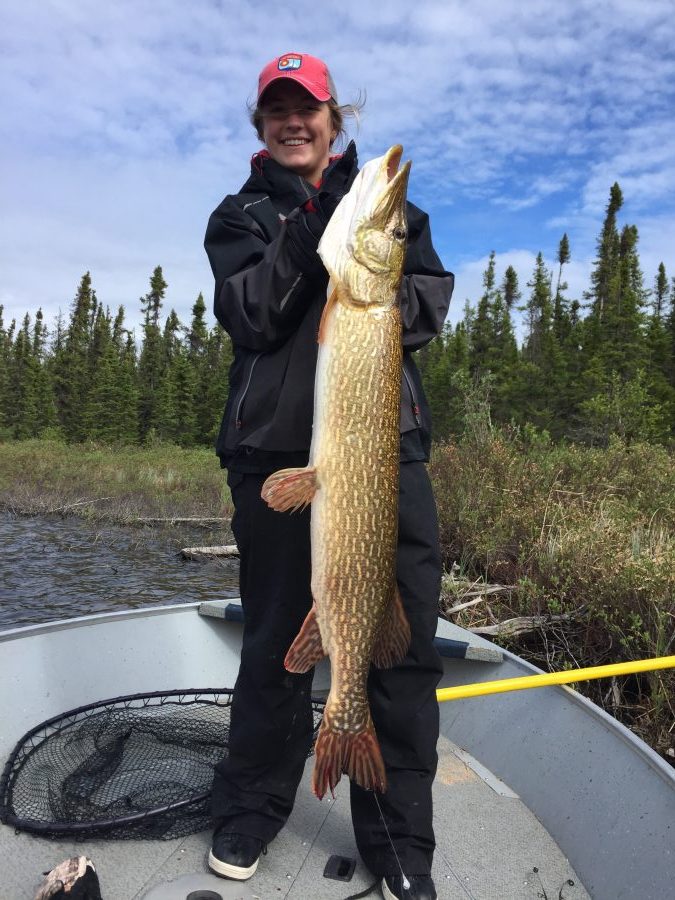 Woman Showing Off Northern Pike Catch from Reindeer Lake
