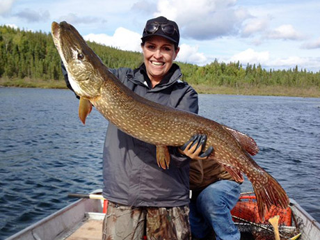 woman holding Northern Pike she caught