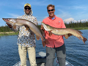 Two Men holding Two large fish
